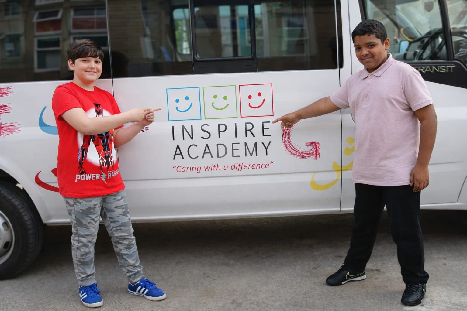 Children boarding Inspire Academy transport bus